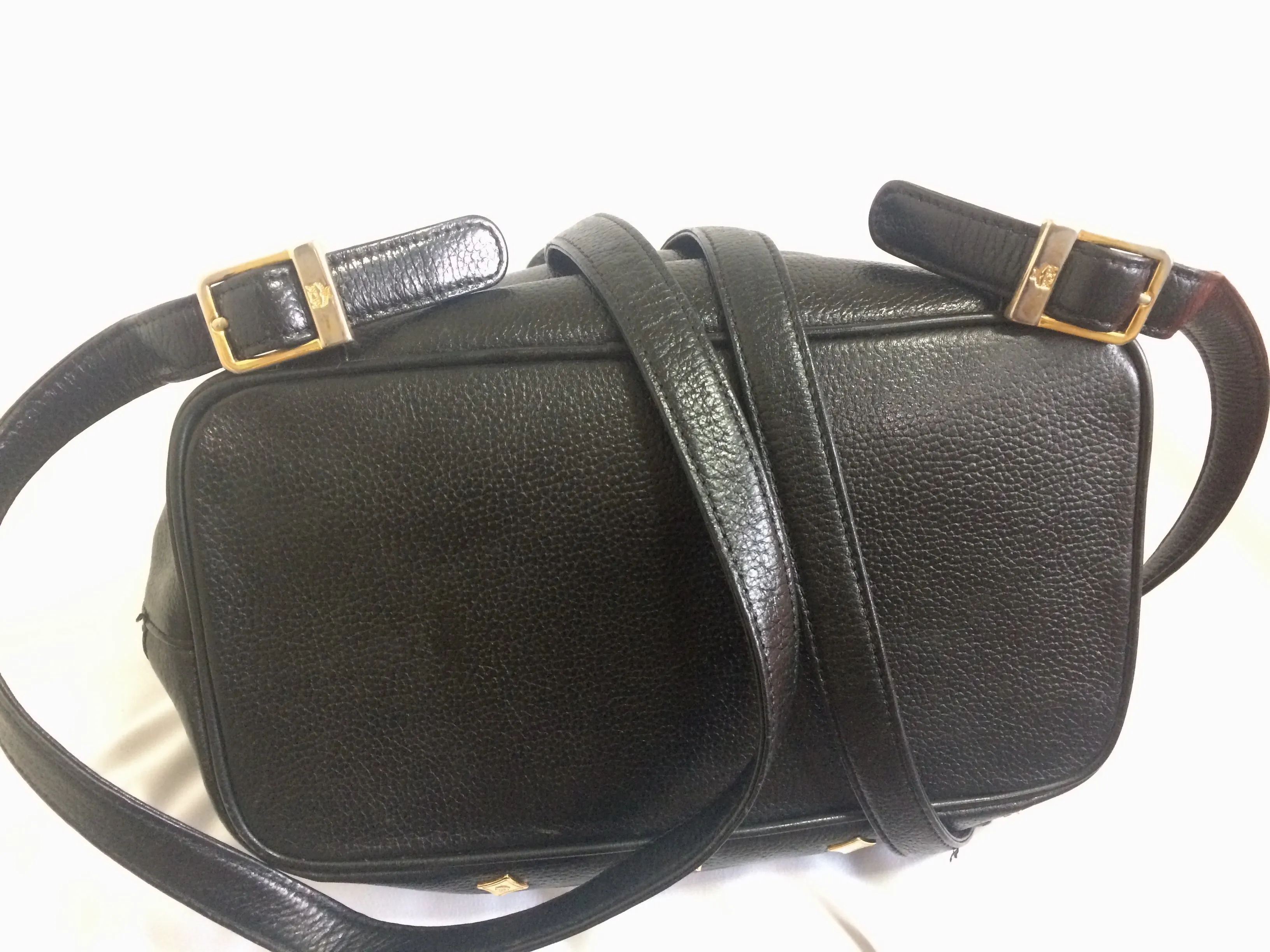 Vintage MCM black leather backpack with golden studded logo motifs. Designed by Michael Cromer. Unisex bag for daily use.